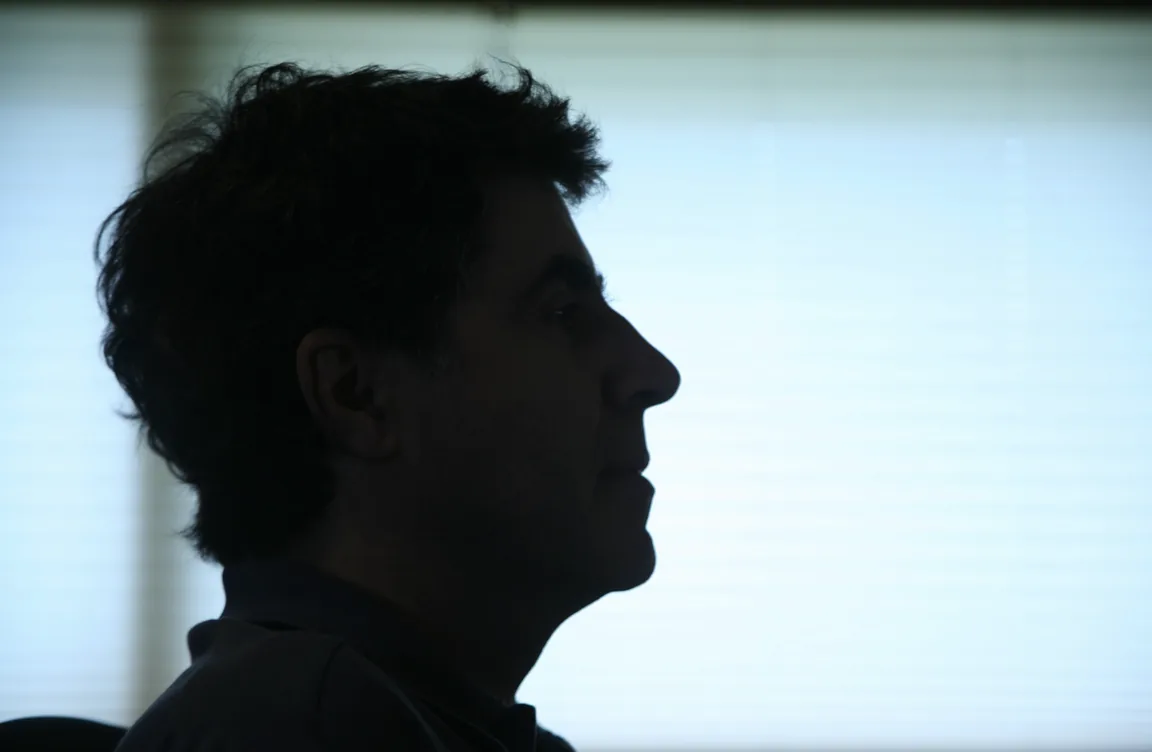 Javier Navarrete in profile, silhouetted against a window