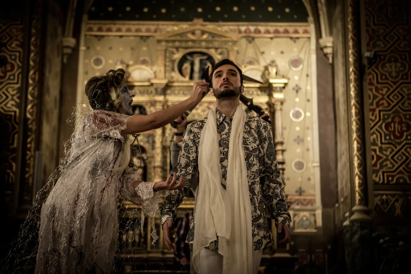 A spectral figure touching Juan’s face in front of the altarpiece